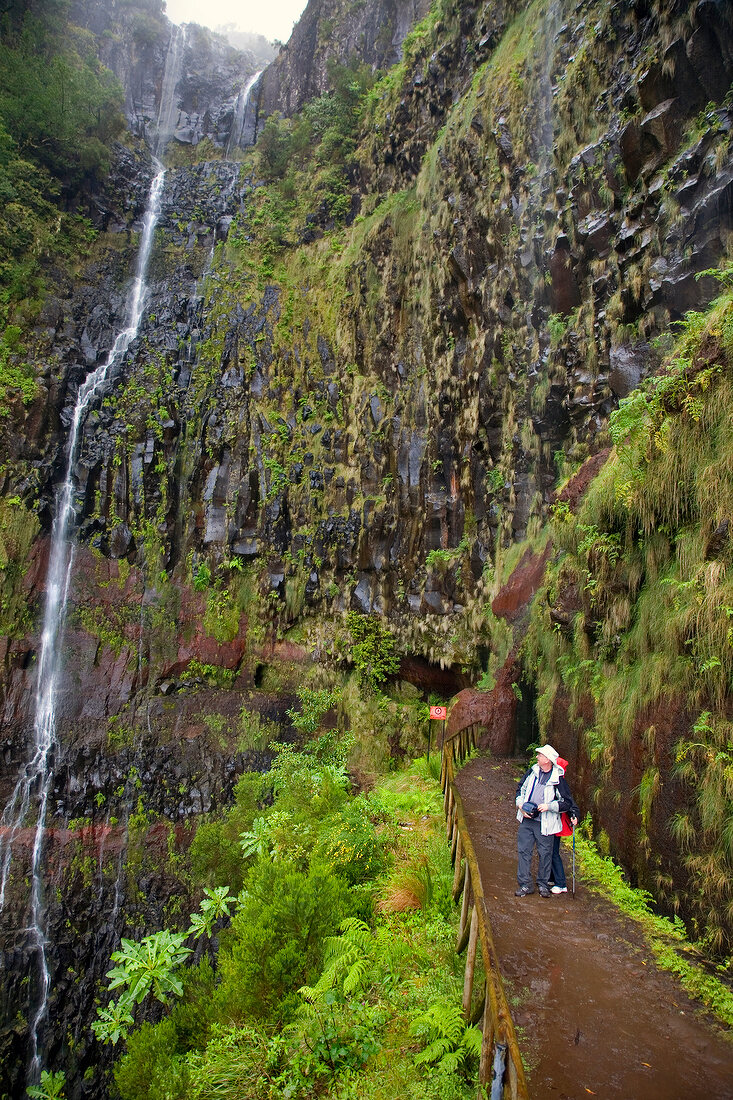 Tourists watching at Levada do Risco waterfall in Madeira, Portugal