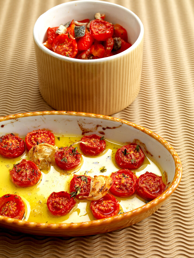 Cherry tomatoes and onions with light sauce in pan while preparing pepper cream