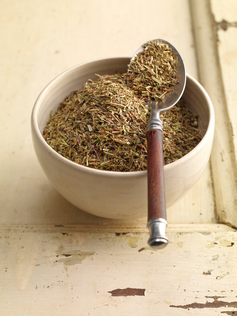 Bowl of dried thyme with spoon