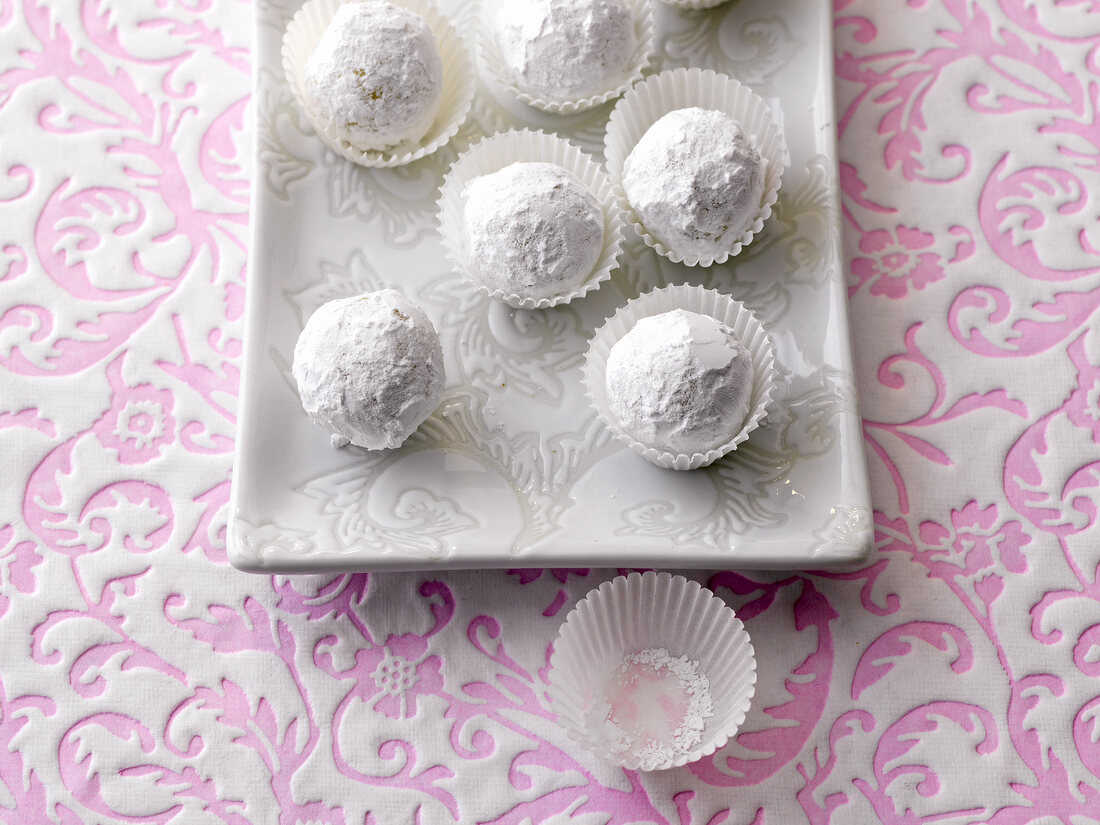 White fruit truffles rolled in powdered sugar on tray