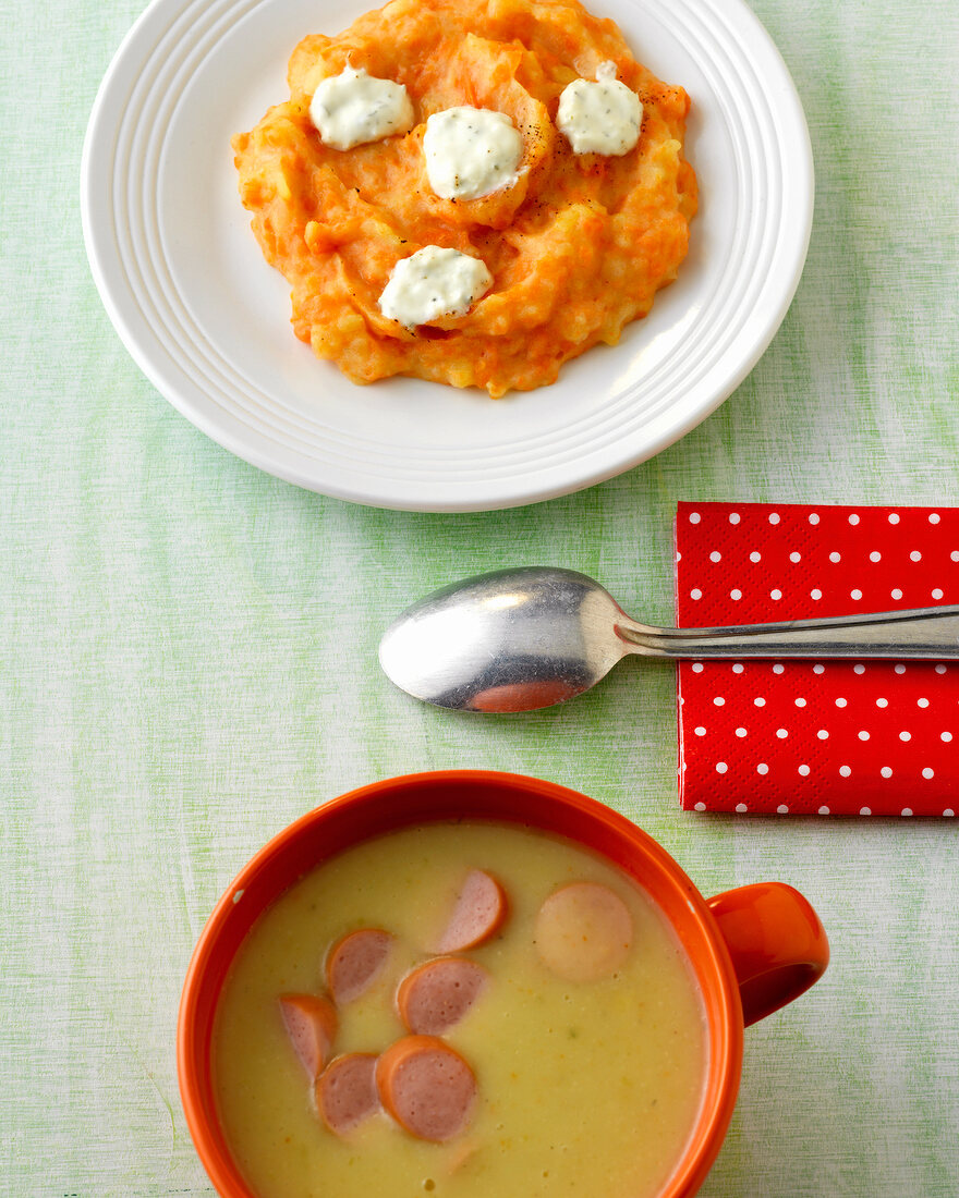 Bowl of potato soup and mashed potatoes on plate