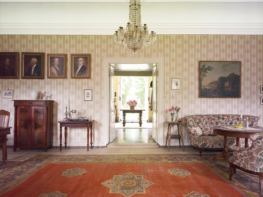 Entrance of living room with chandelier and carpet in Rieseby, Germany