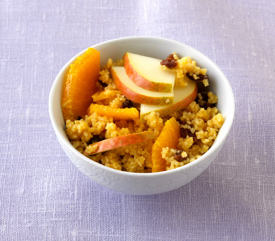 Sweet Couscous salad with raisins and pear in bowl