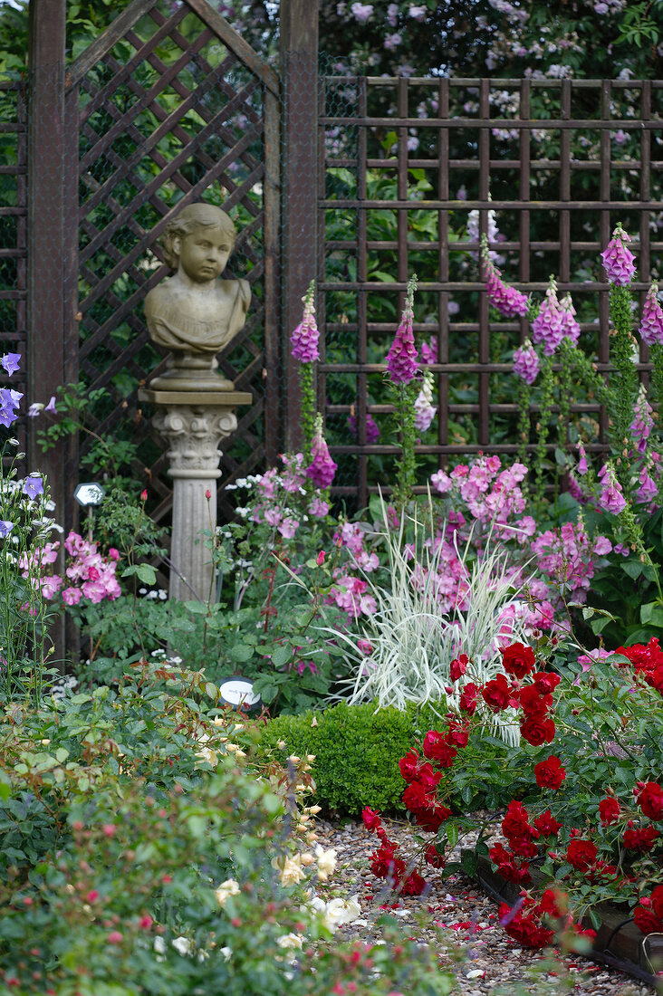 Bust between flowers in garden