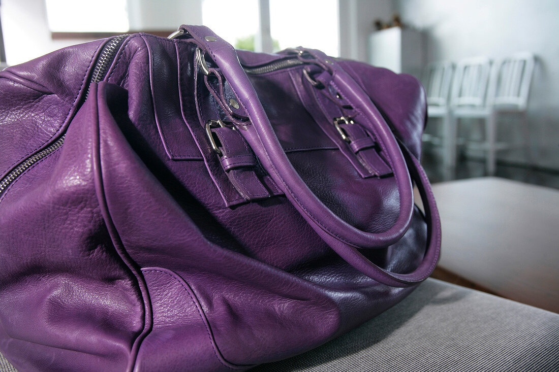 Close-up of violet leather handbag