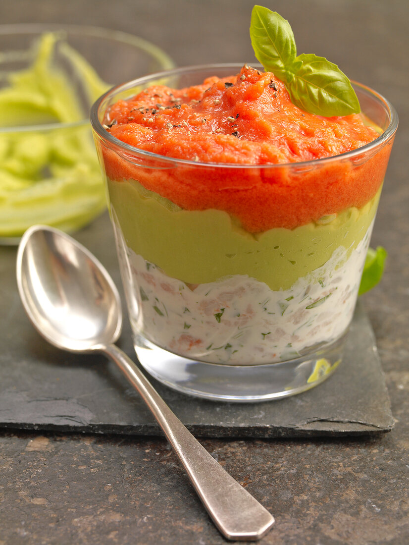 Shrimp cocktail with guacamole, tomato sauce and hern in glass