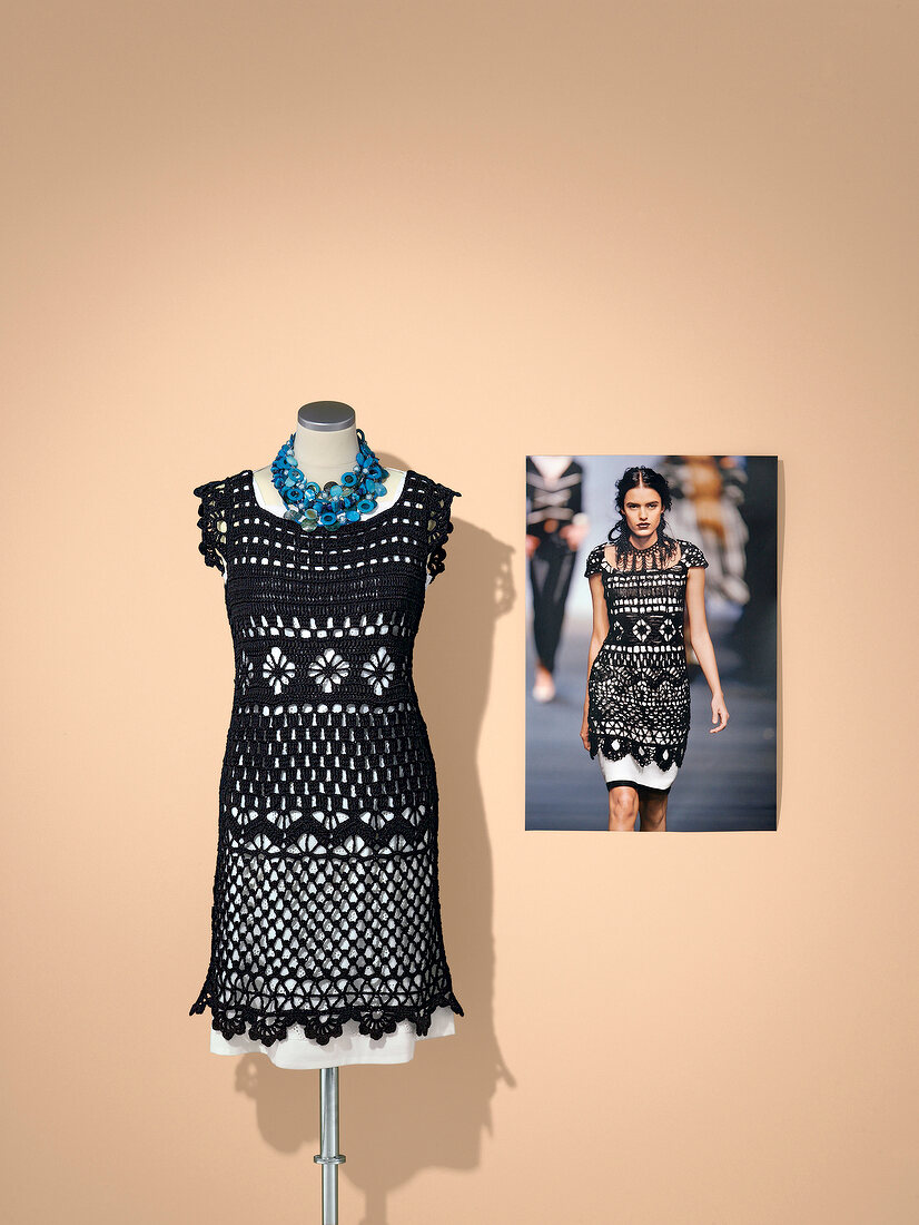 Black crochet dress and necklace on mannequin