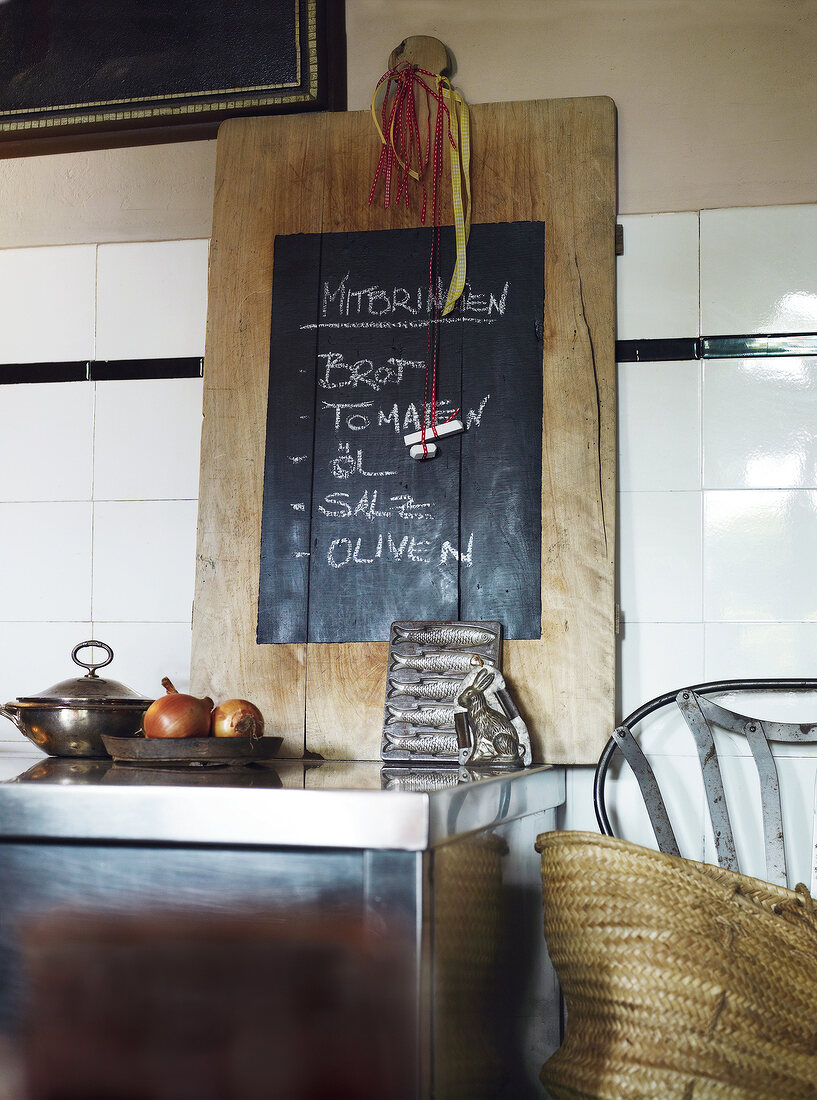 Wooden board with blackboard on wall in rural kitchen