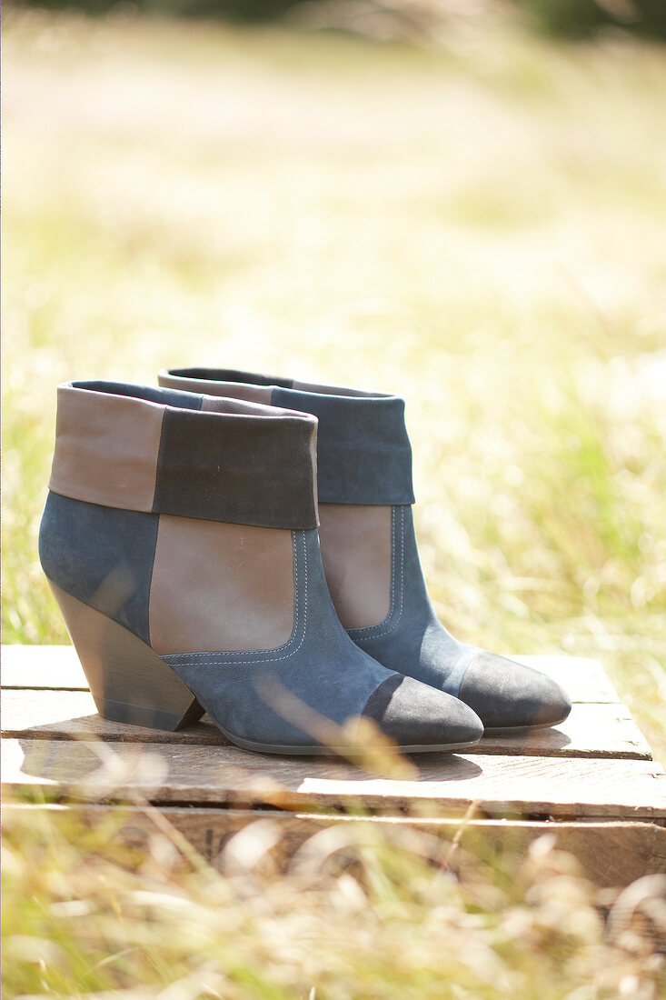 Pair of suede boots in meadow