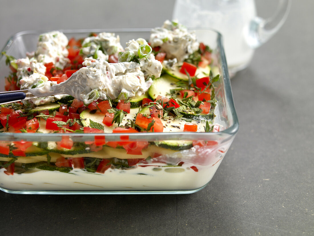 Goat cheese, potato, zucchini gratin, tomato, sage and cream in serving tray