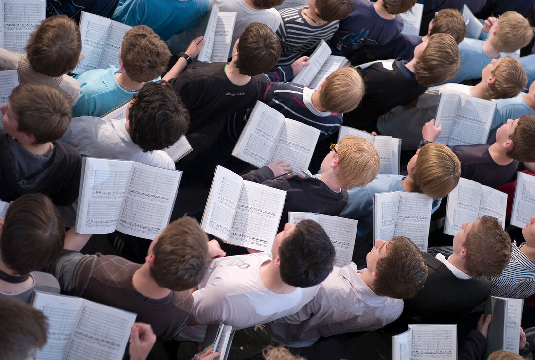 Choir boy's holding music sheets and rehearsing in cathedral, Elevated view