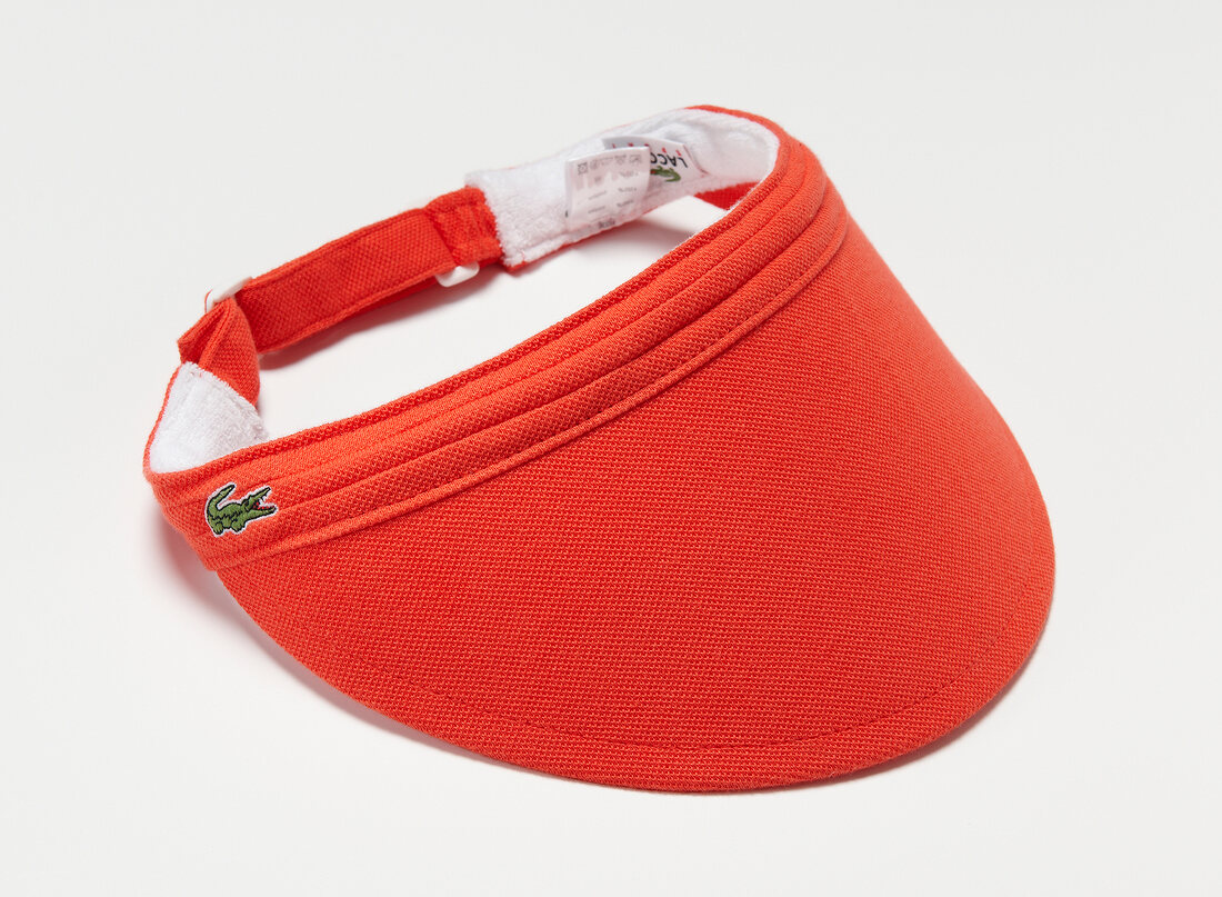 Close-up of red visor on white background