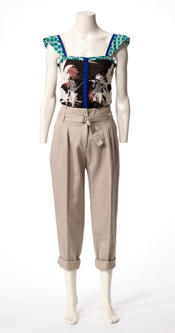 Patterned shirt and gray pants on mannequin against white background
