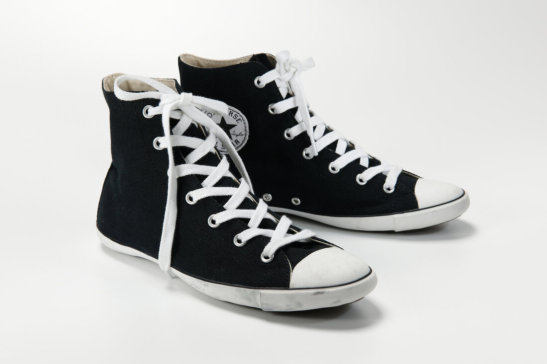 Pair of black chucks with white shoe lace on white background