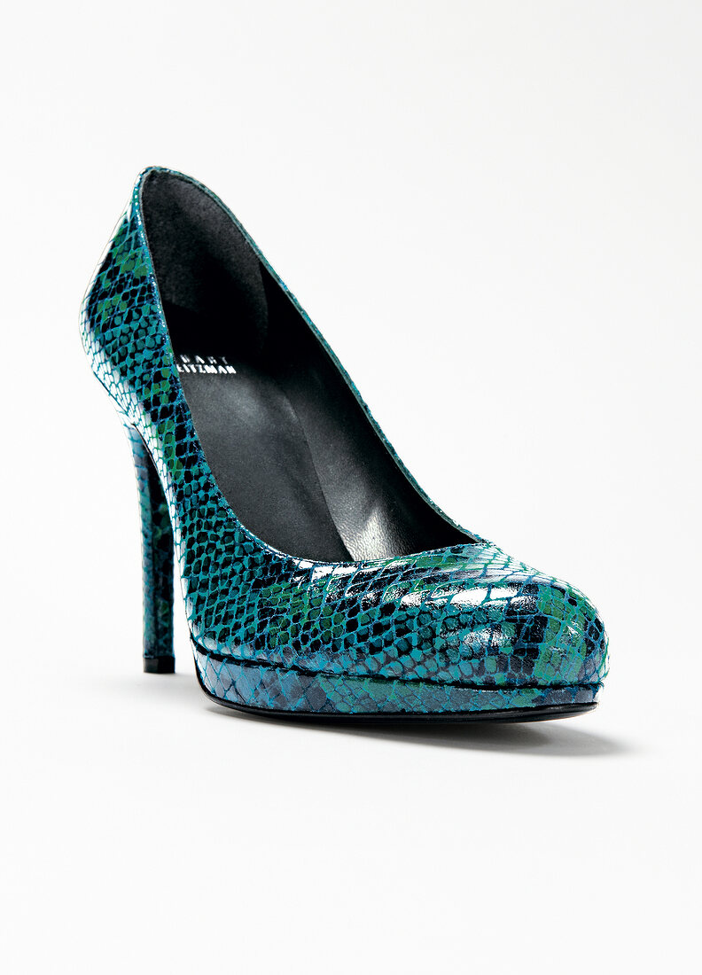 Close-up of green snake leather platform pump on white background
