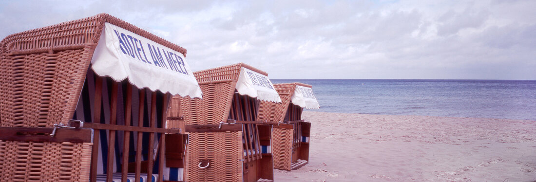 Three hooded beach chair on beach, Stralsund, Mecklenburg-Vorpommern, Germany