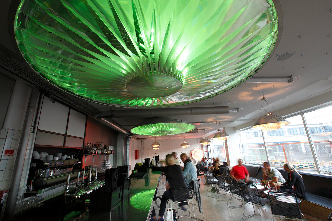 People at Karriere Bar with green lamps on ceiling, Copenhagen, Denmark