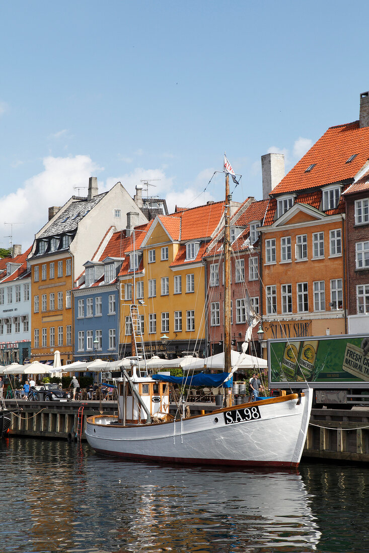 White sailboat and buildings of old town in Nyhavn, Copenhagen, Denmark