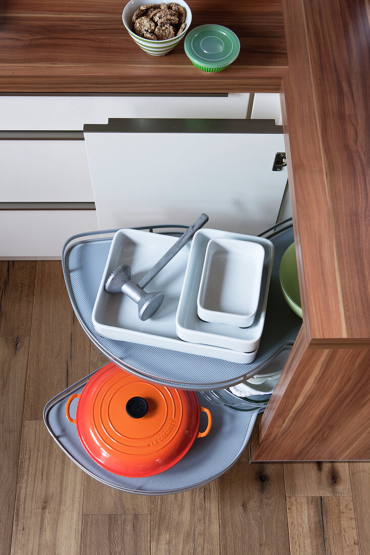 Extendable trays from an open kitchen cabinet