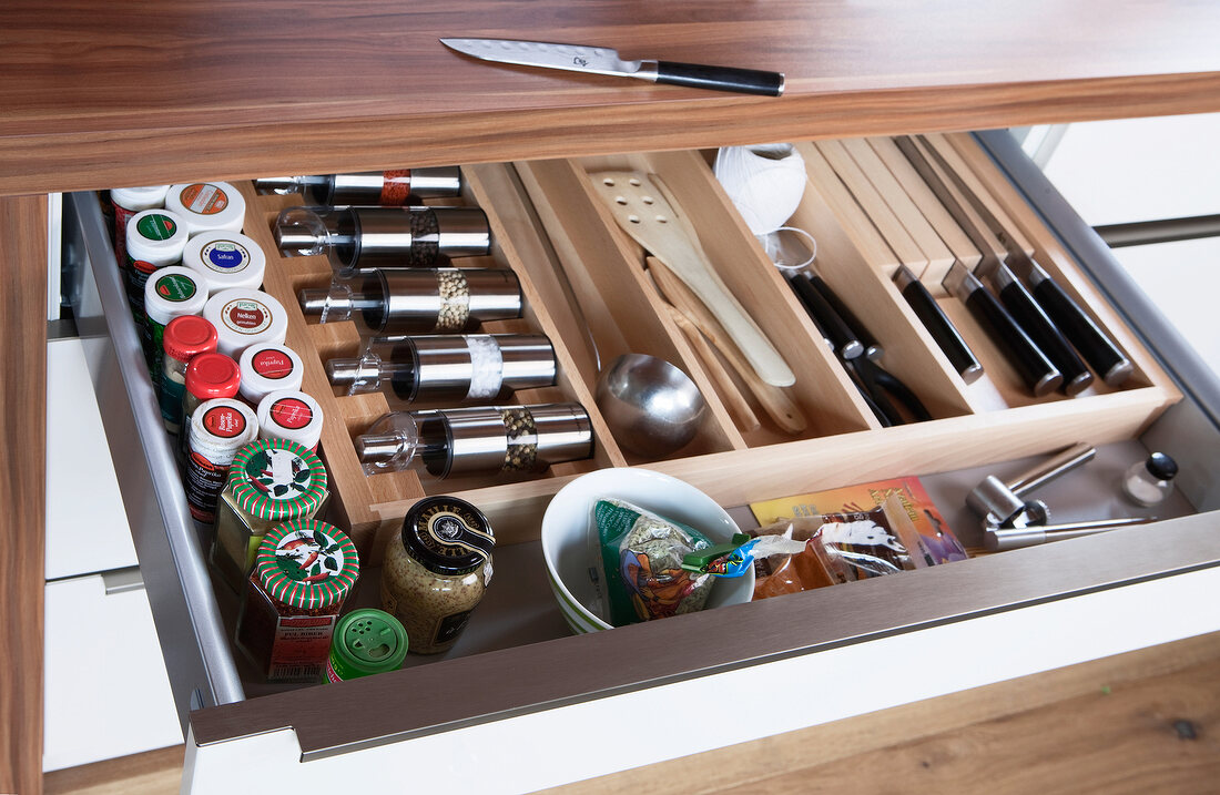 Close-up of pulled out kitchen drawer with spices