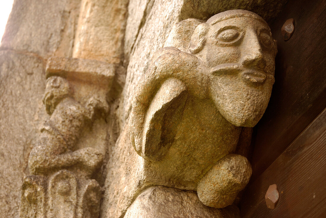 Stone face of mythical creatures in Church of San Nicola, Ticino, Switzerland