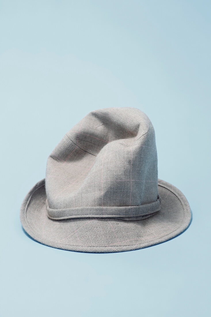Gray plaid hat on light blue background