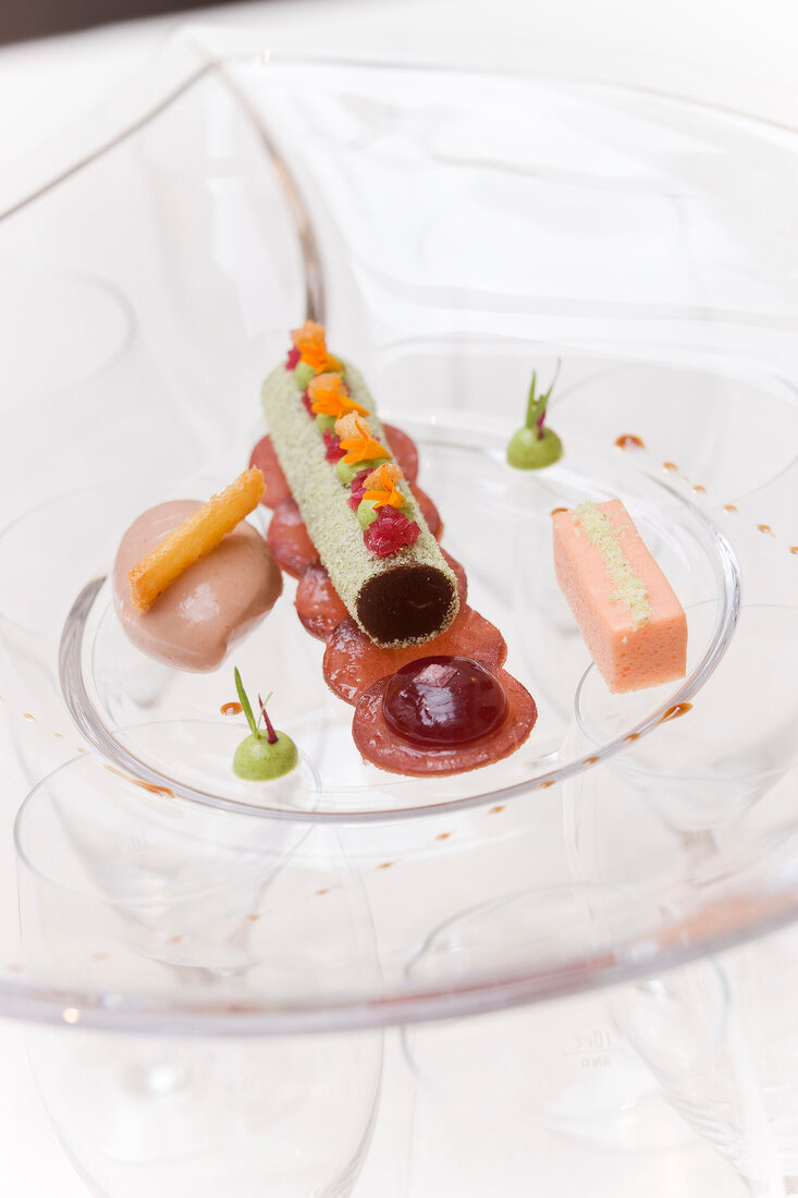 Close-up of pastrami, mousse and carpaccio of reindeer on glass plate