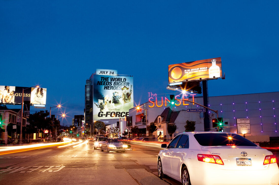 Illuminated city at night with cars on road, Los Angeles, California, USA