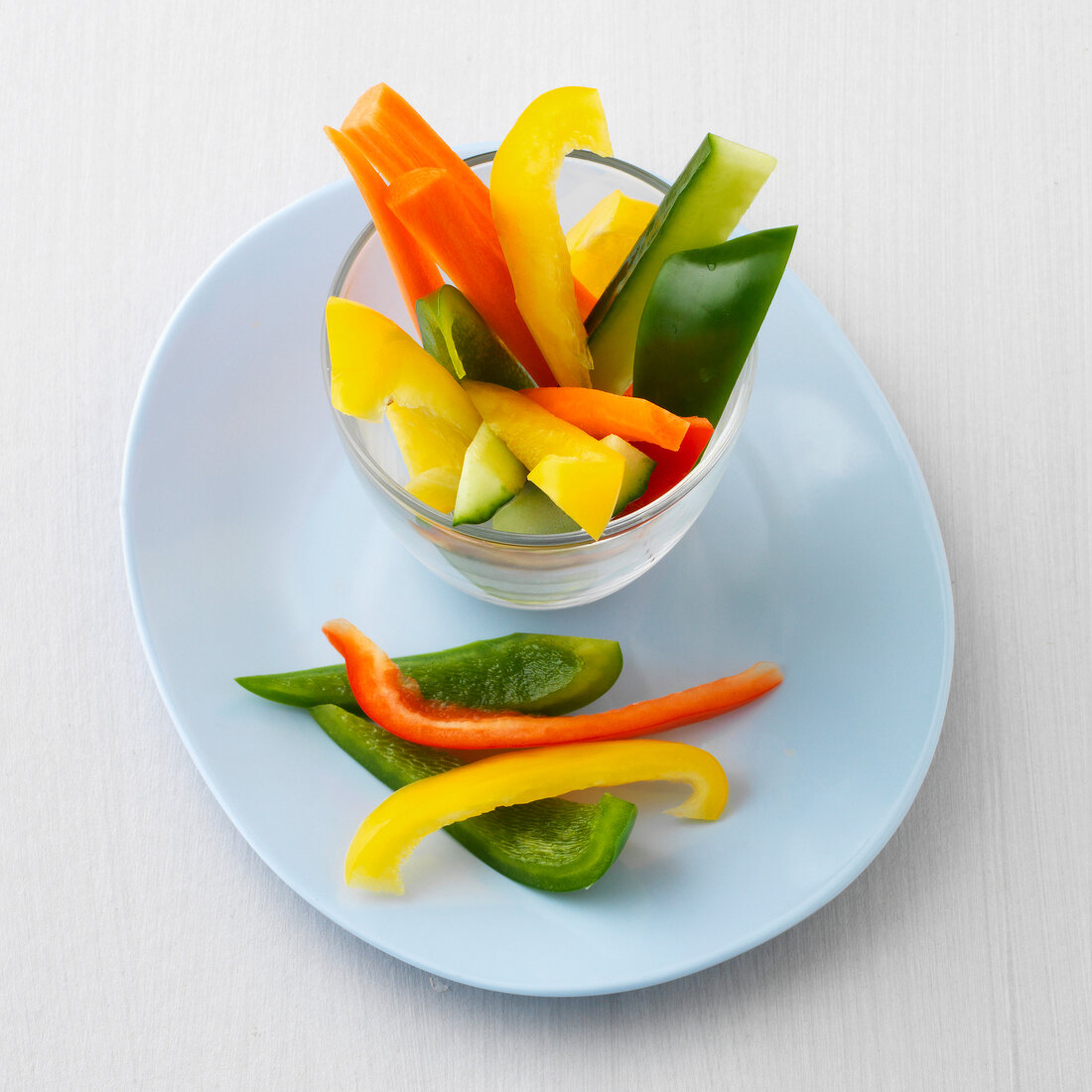 Yellow and green peppers in glass bowl