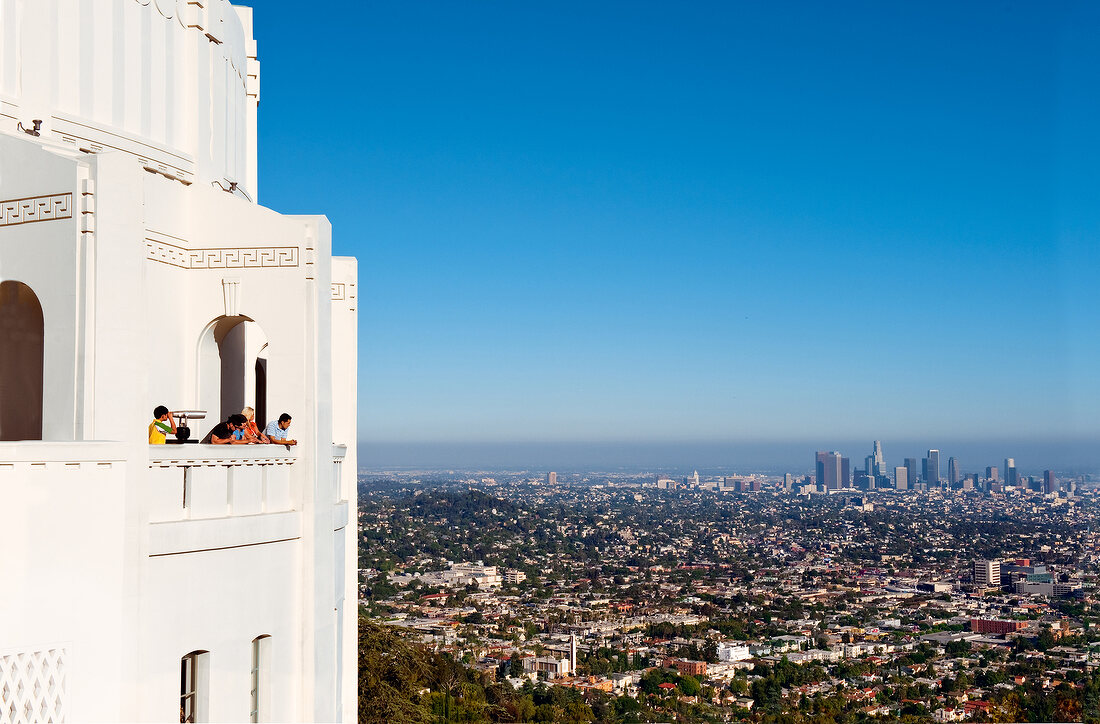 Tourist looking at cityscape from balcony, Los Angeles, California, USA