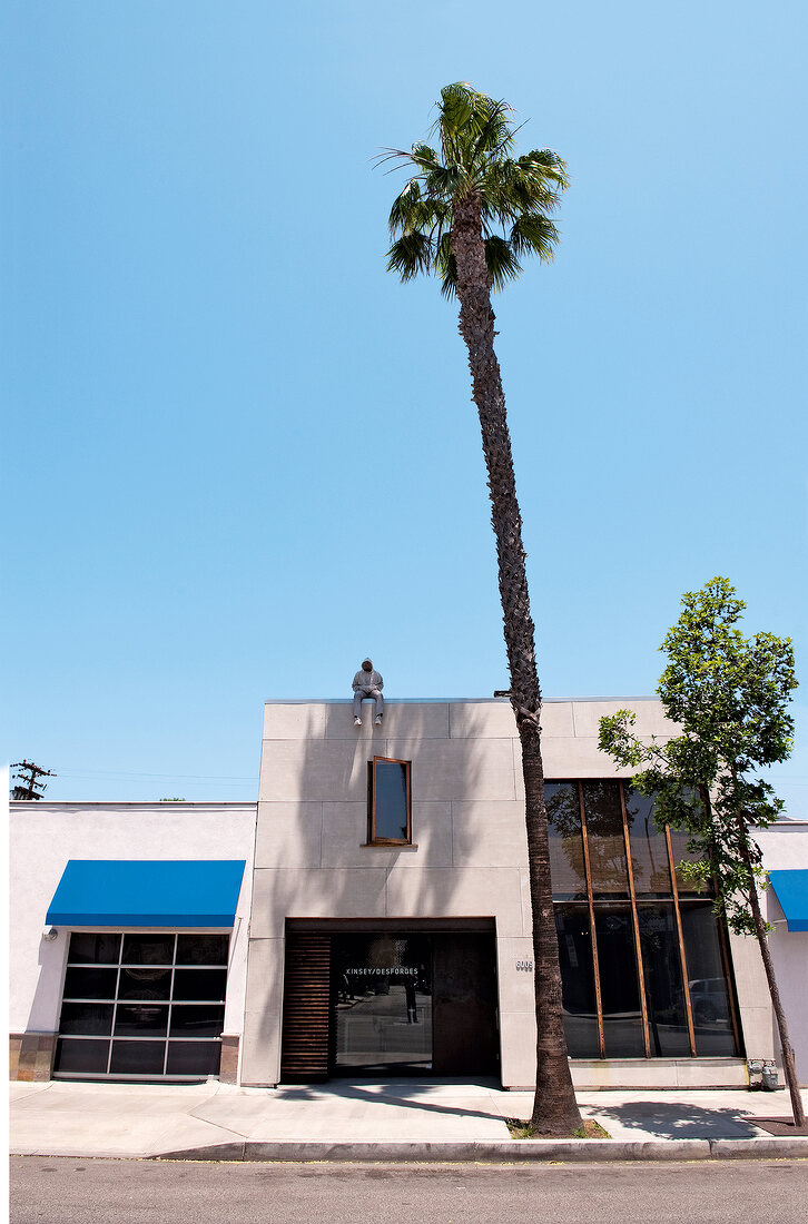 Man sitting on the entrance of Kinsey Desforges Gallery, Los Angeles, California, USA