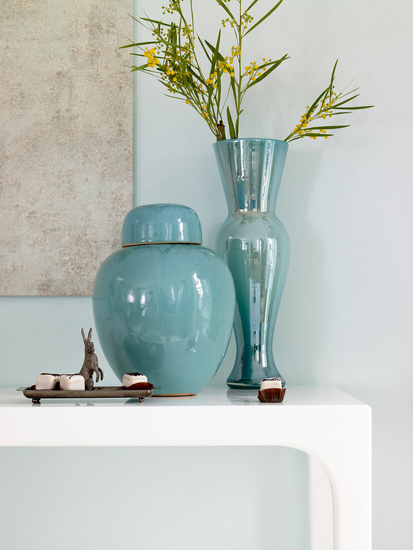Turquoise colour bowl and vase on sideboard