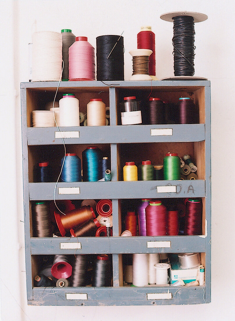 Different colourful yarn on shelf at workshop