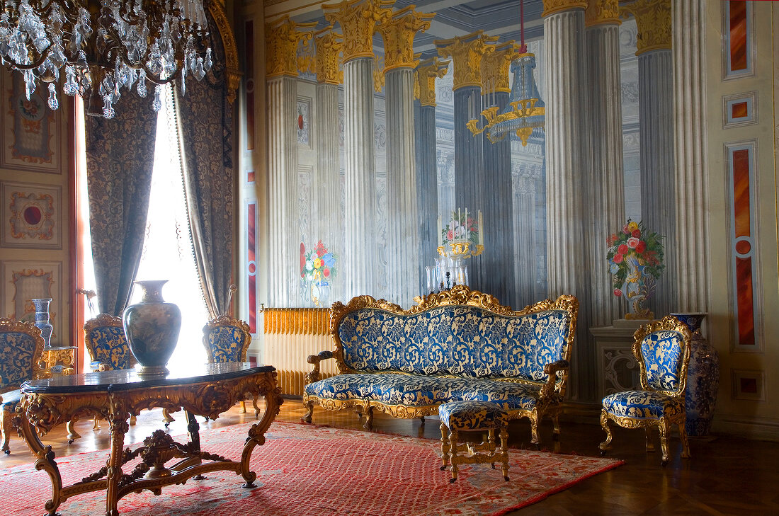Room in Dolmabahce Palace with vases, crystal chandeliers and sofas in Istanbul, Turkey