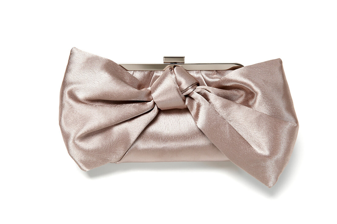Close-up of satin clutch bag on white background