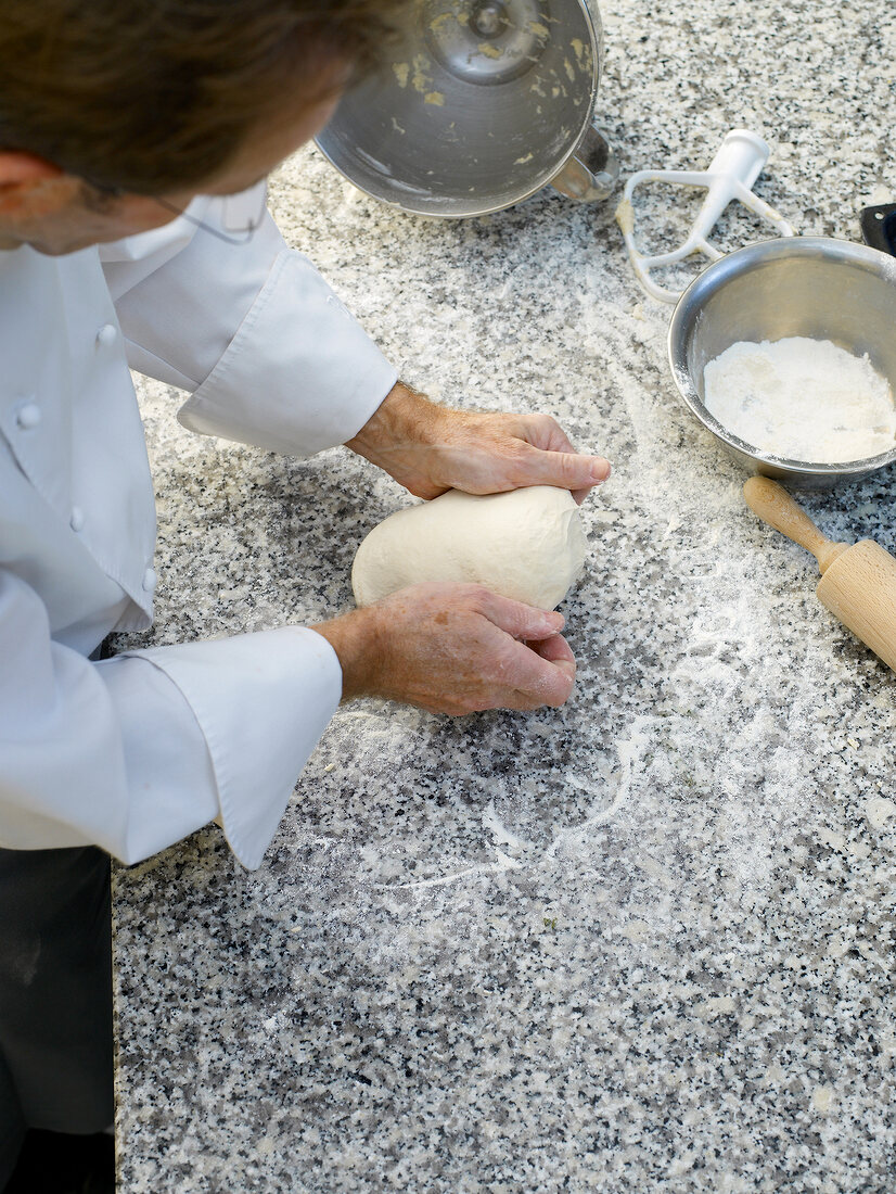 Man kneading dough for focaccia bread