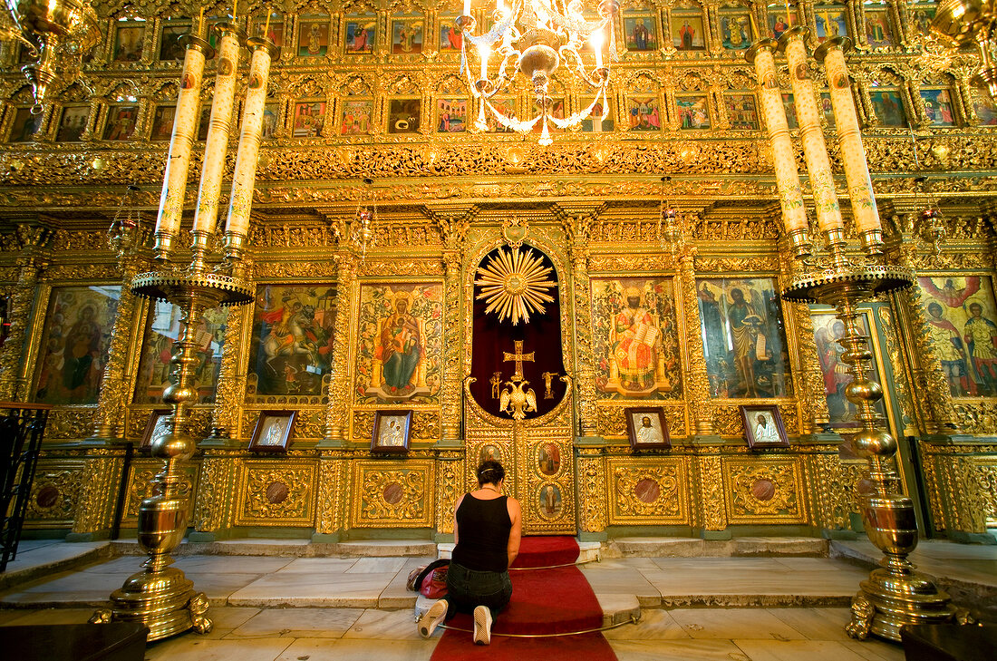 Woman kneeling and worshipping in Hagios Georgios church in Istanbul, Turkey