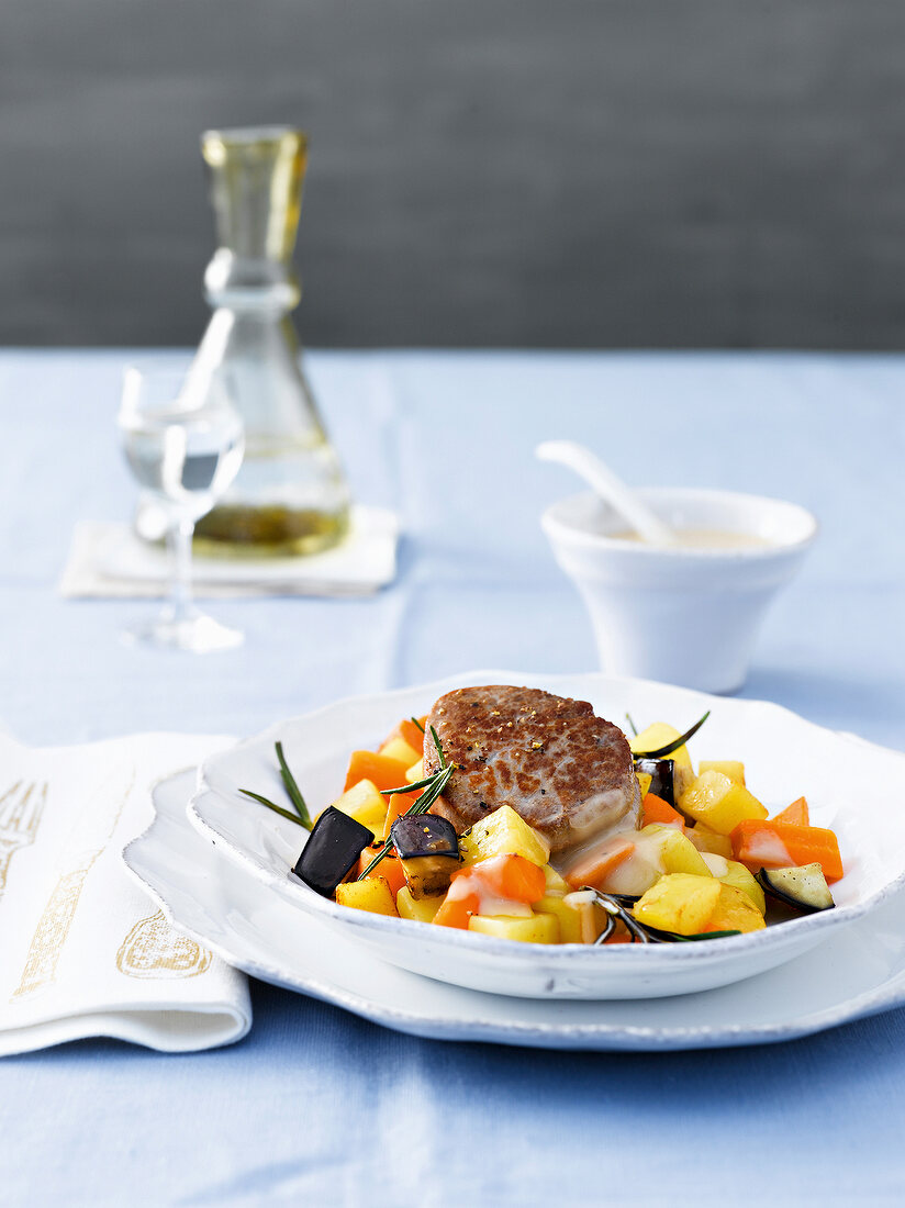 Pork medallions with carrot vegetables on plate