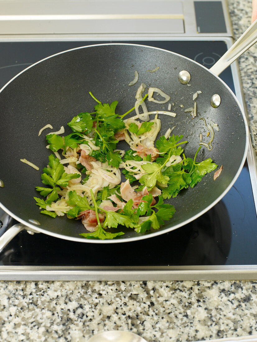 Pointed cabbage roulade being stir fried in pan