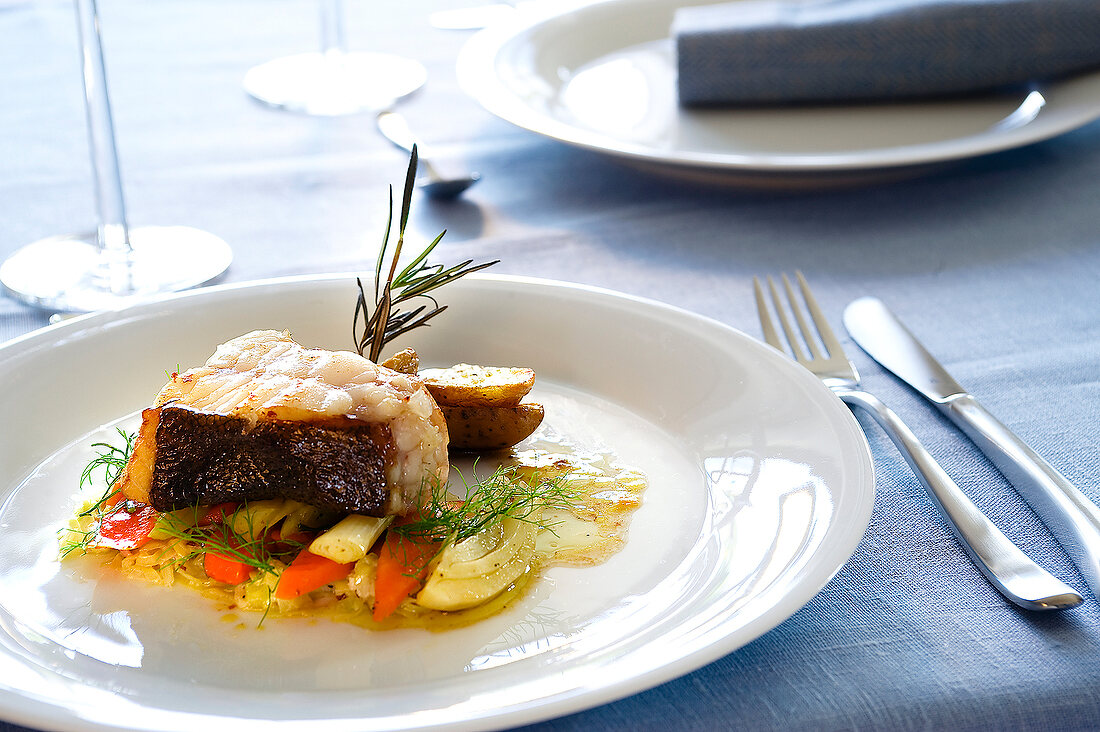 Turbot with vegetables on dish