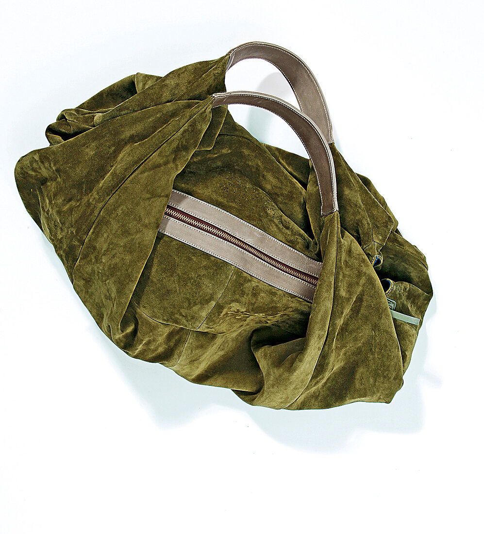 Green suede bag on white background