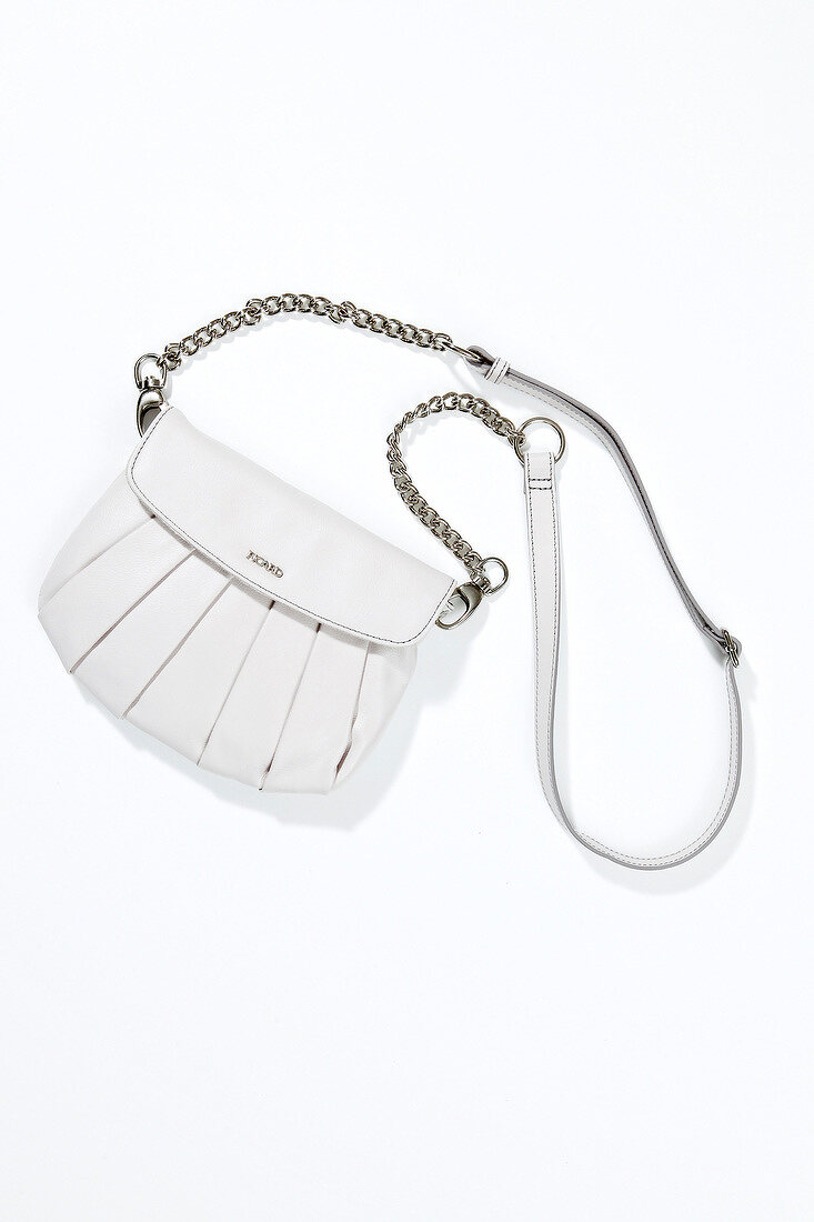 Close-up of white sling bag on white background