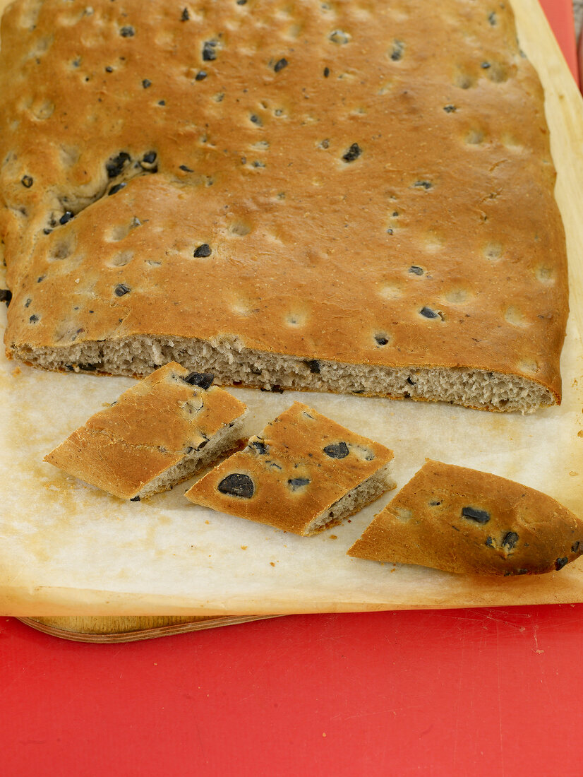 Close-up of sliced and whole focaccia bread