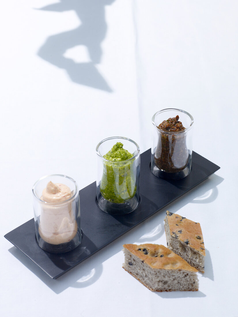 Three dips of salmon, pesto and olives for focaccia bread