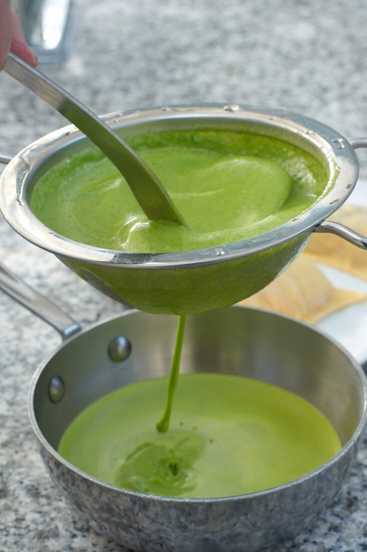 Lettuce sauce being filtered