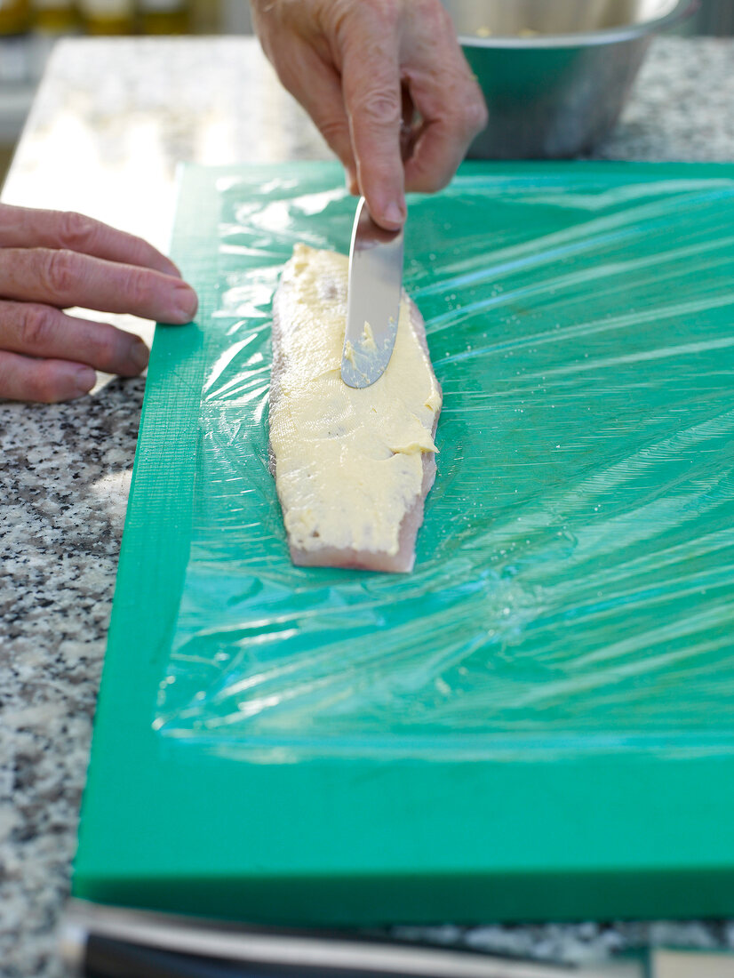 Preparing roulade with artic char on cutting board