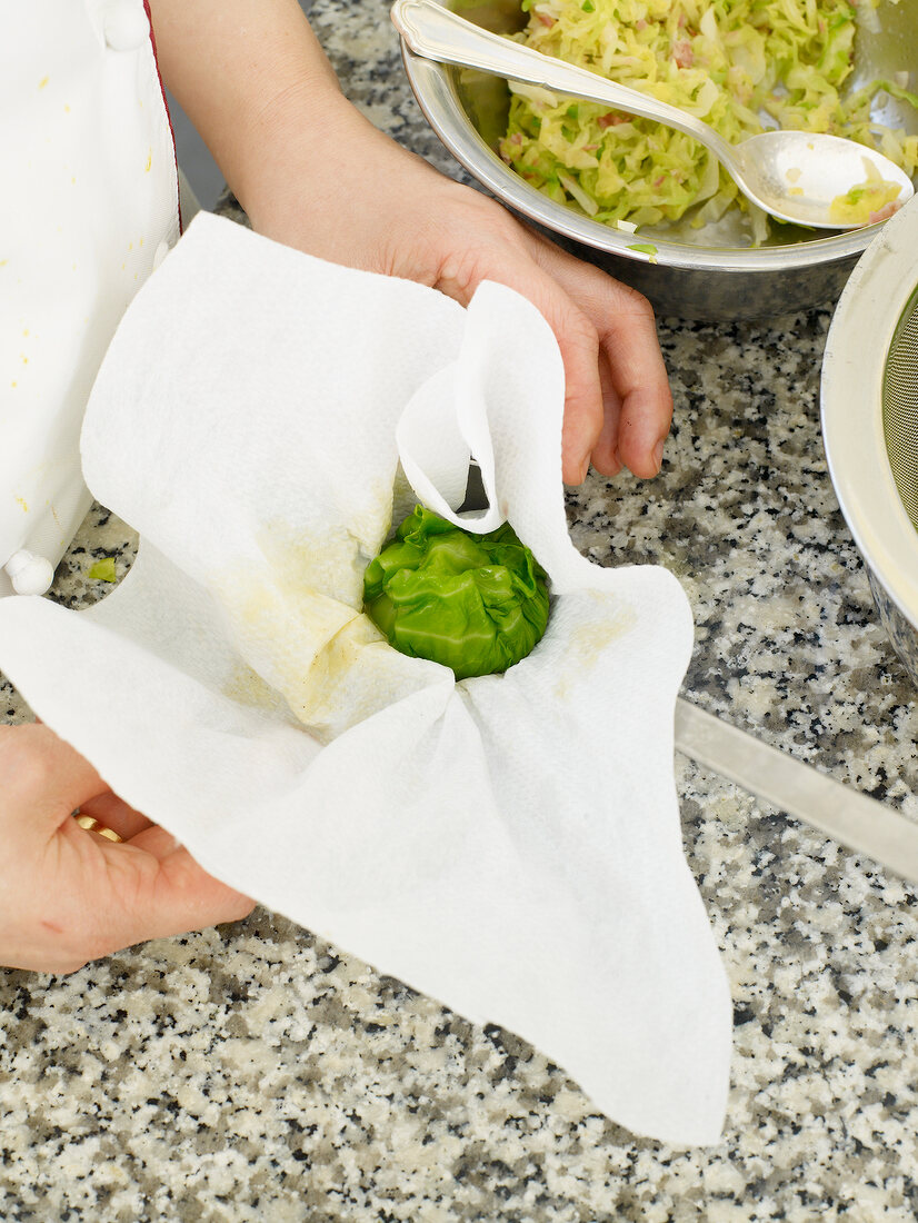 Cabbage balls being prepared in paper