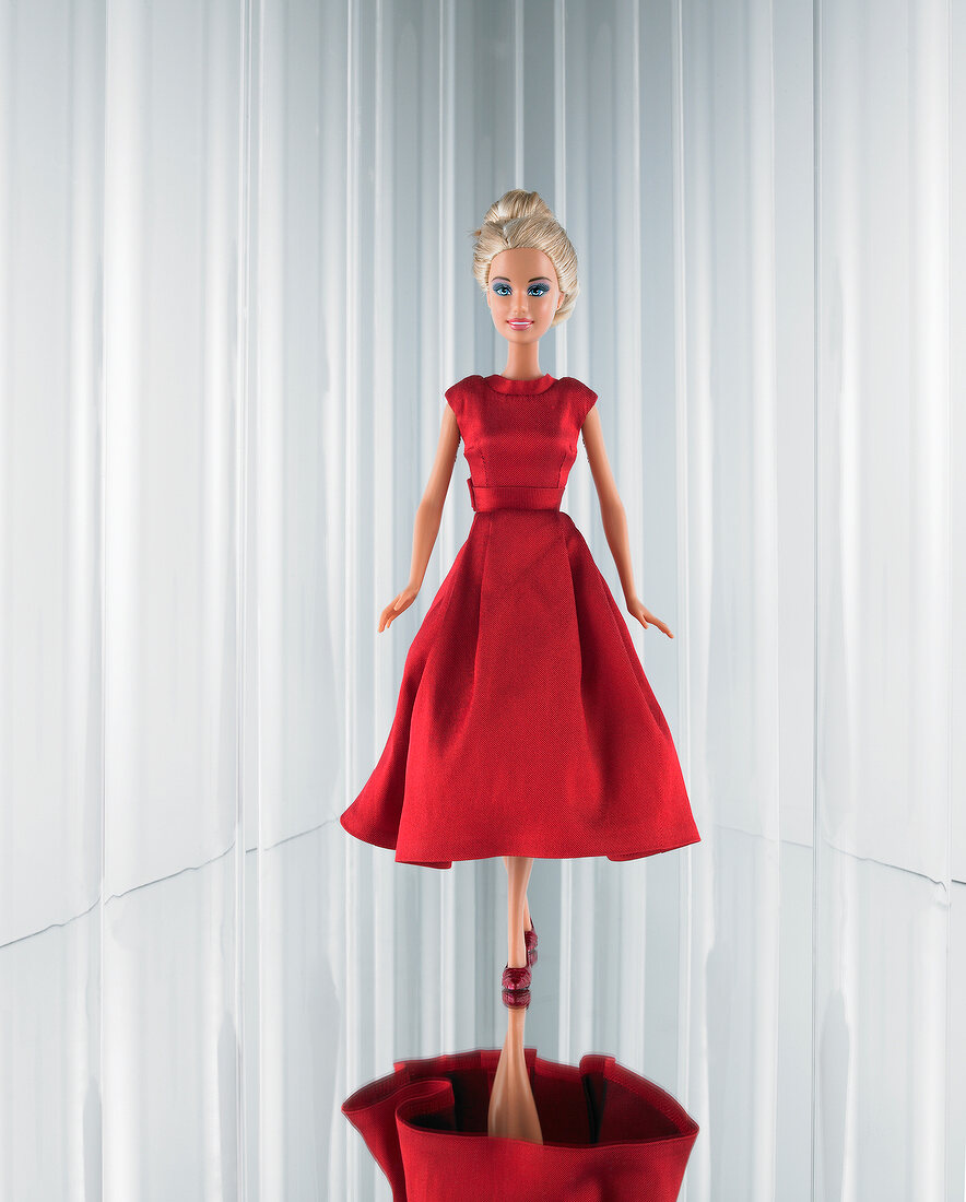 Close-up of Barbie wearing elegant red couture dress