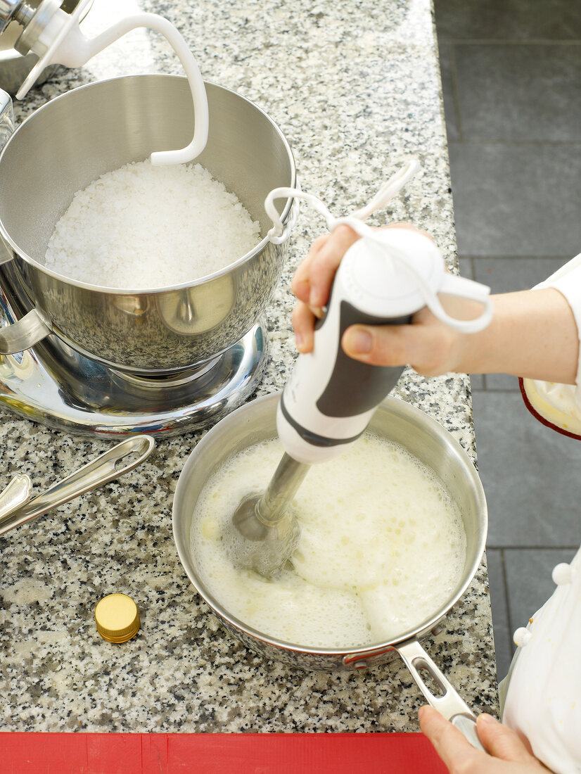 Mixing ingredients with hand blender in pan