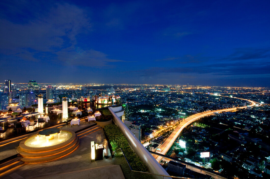 View of illuminated cityscape at night from terrace, Bangkok, Thailand